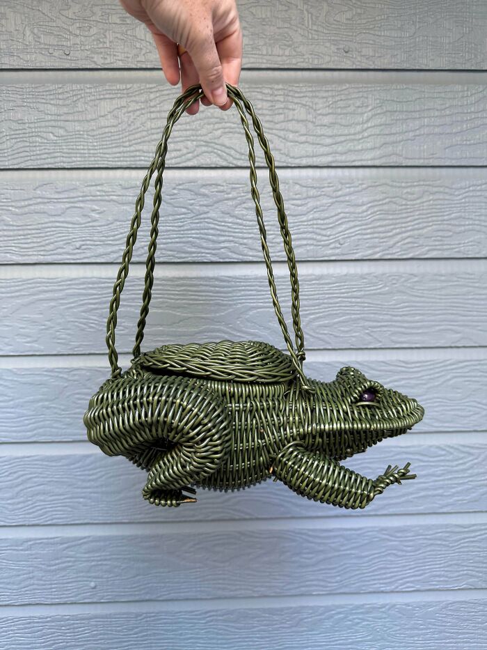 A quirky green wicker frog-shaped purse, a delightful and unusual thrift store jackpot.