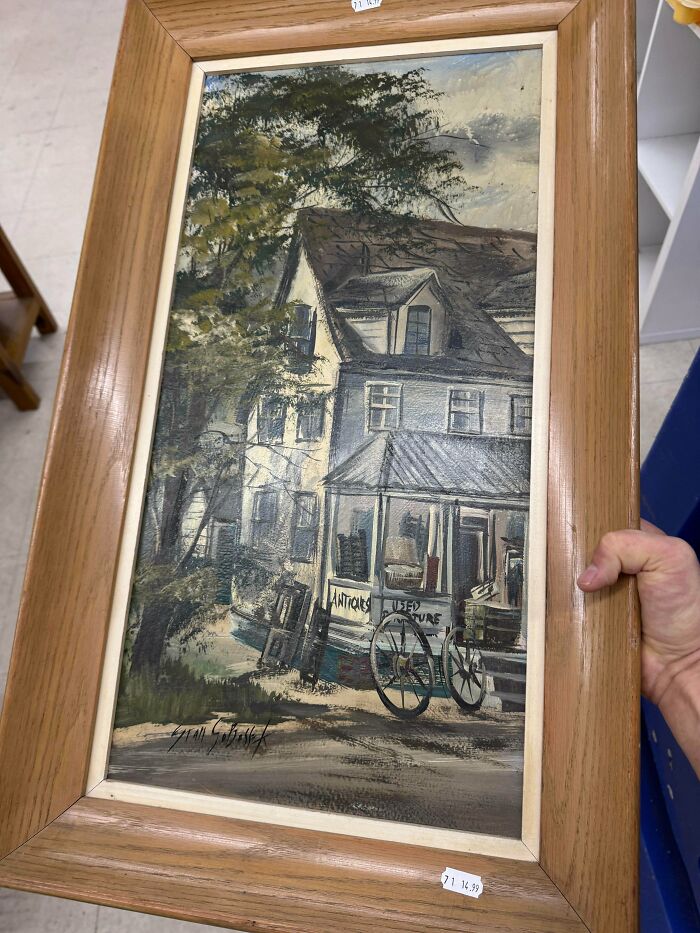 An old painting depicting a building with 'Antiques' and 'Used Furniture' signs, a charming thrift store jackpot.