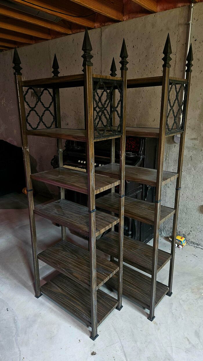 A pair of unique, ornate metal and wood shelving units discovered at a thrift store, a true jackpot find.