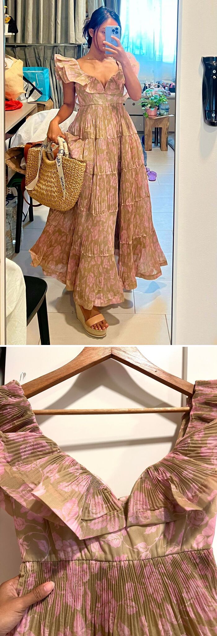 A woman wearing a pleated pink and brown floral maxi dress, a stylish jackpot from a thrift store.