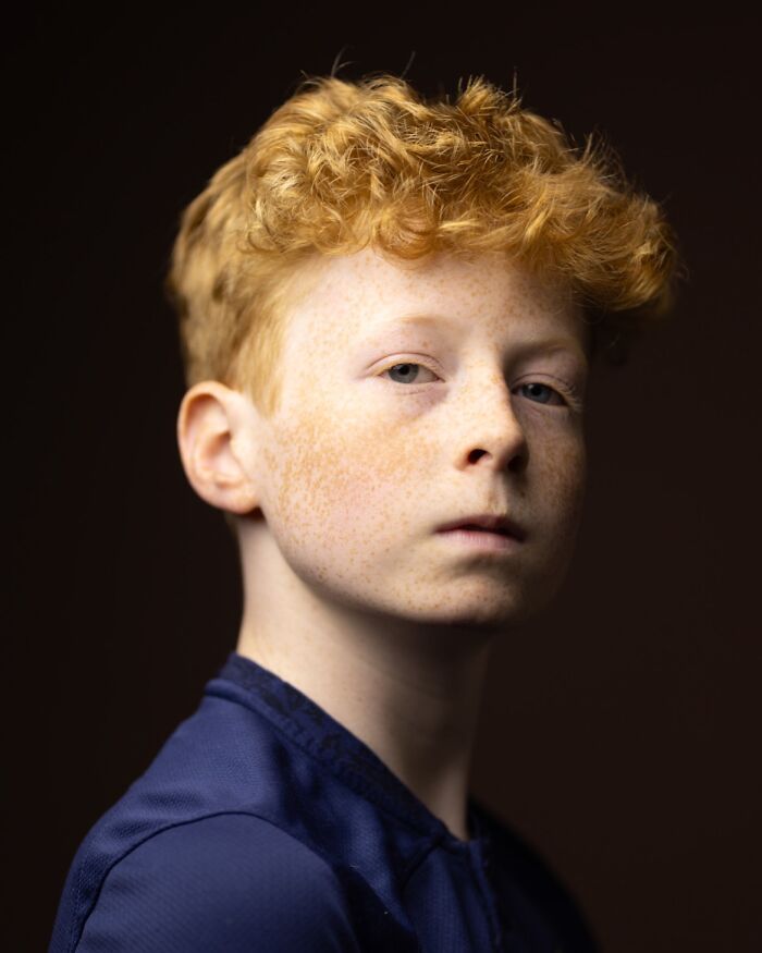 A serious natural redhead boy with freckles, celebrating natural redheads.