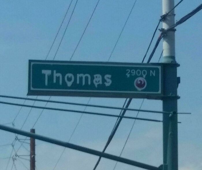 Street sign for Thomas street melting due to extreme summer heat.