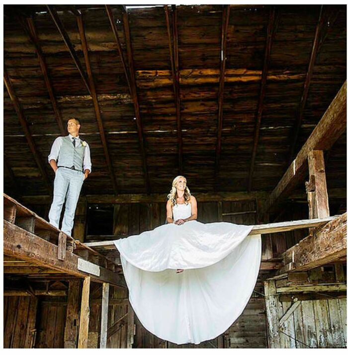 A confusing pic of a bride and groom in a barn, with the bride sitting on a high beam, creating misleading headlines.