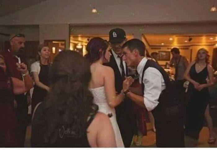A confusing pic of a man appearing to kiss a woman at a party, creating misleading headlines.