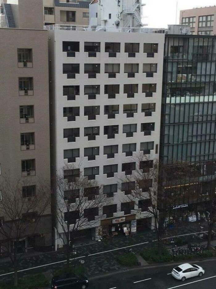 A confusing pic of a building with rows of windows that look like a repeating pattern, misleading the eye.