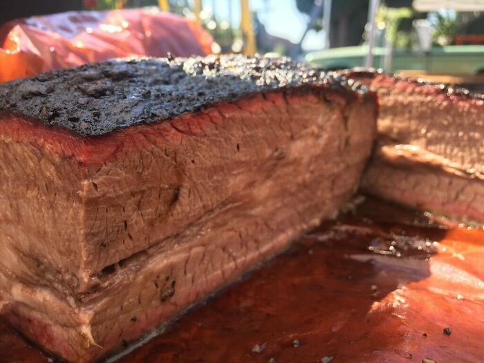 A confusing pic of a large cut of smoked brisket, with misleading headlines that may melt your brain.