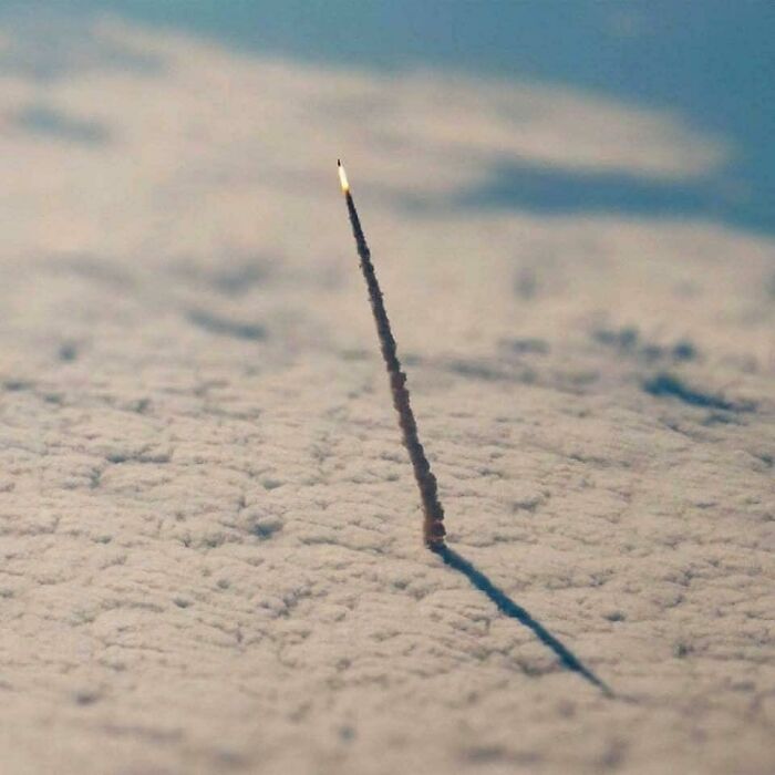 A confusing pic of a rocket launch, appearing to fall into a thick layer of clouds.