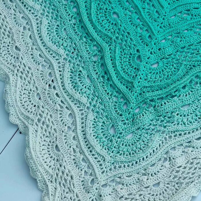 Detailed crochet blanket with intricate green ombre design