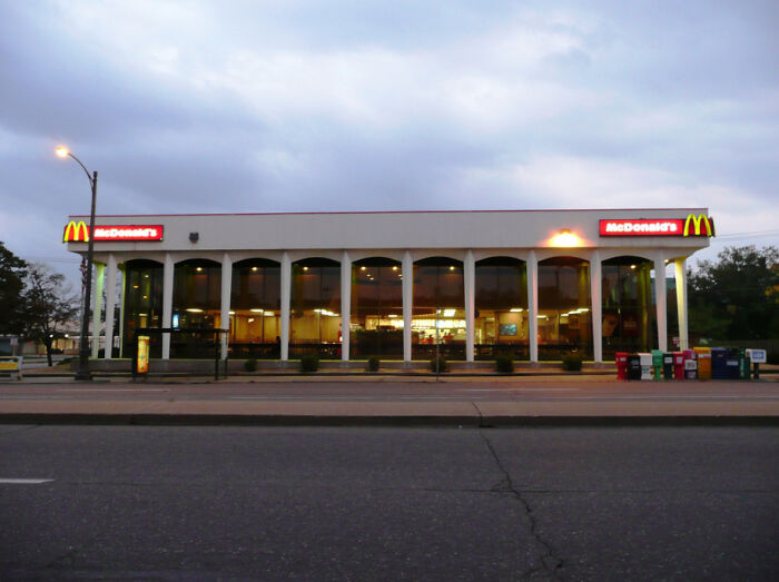 An old McDonald's restaurant at dusk, a building that is pretending to be something it is not.
