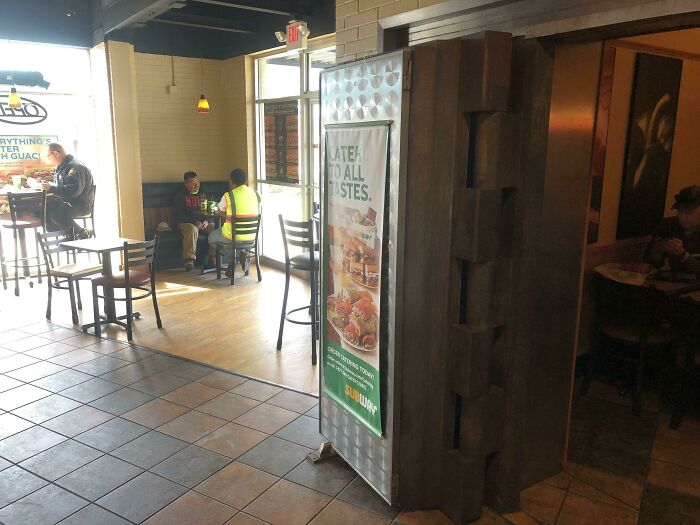 The interior of a Subway restaurant, a space pretending to be a standalone restaurant while inside another business.