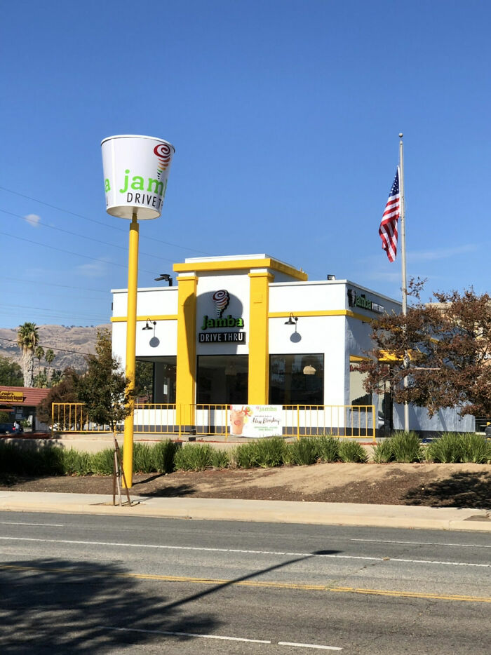 A building pretending to be something it is not; a Jamba Juice drive-thru with a giant smoothie cup sign.