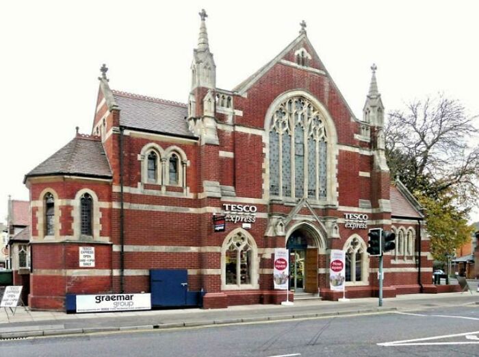 A building pretending to be something it is not; a Gothic-style red brick building that is now a Tesco Express.