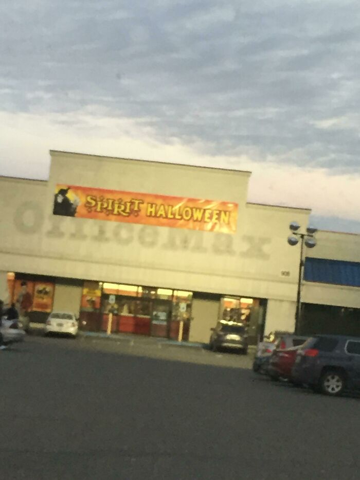 A Spirit Halloween banner over a building that is clearly pretending to be an OfficeMax store.