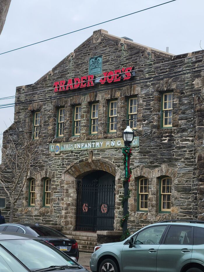 A Trader Joes grocery store housed in an old stone building, pretending to be something else.