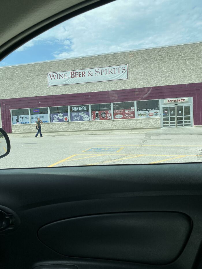A Wine, Beer & Spirits store pretending to be a grocery store, with a person walking outside.