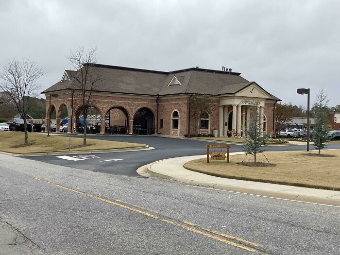 Large brick building with columns, one of many buildings pretending to be something else.