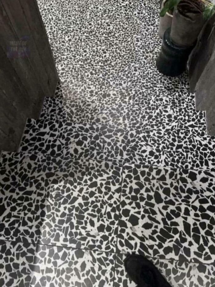 A confusing black and white patterned floor that creates a dangerous optical illusion, making stairs hard to see.