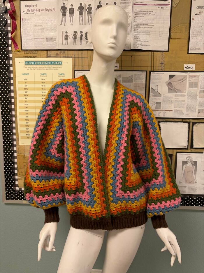 Colorful striped crochet cardigan on a mannequin