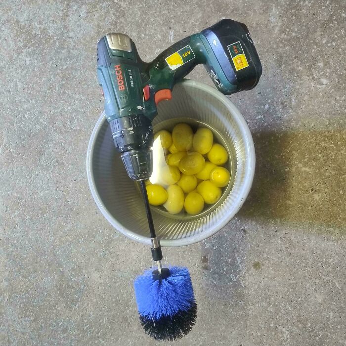 A power drill with a brush attachment cleaning a bucket of potatoes, showcasing clever solutions from random junk.