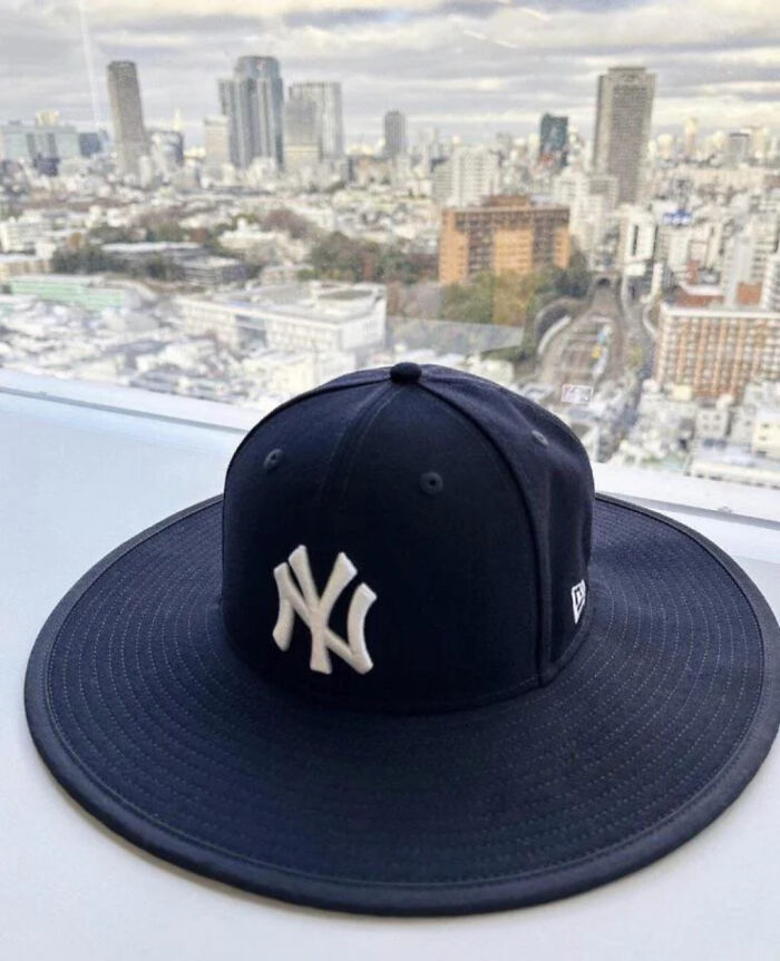 A curious pic of a New York Yankees baseball cap with an unusually wide brim, an image people cannot explain.