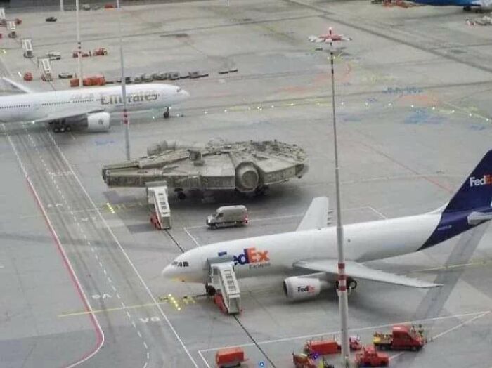 A Millennium Falcon model on an airport tarmac next to real planes, one of the pics people cannot explain.