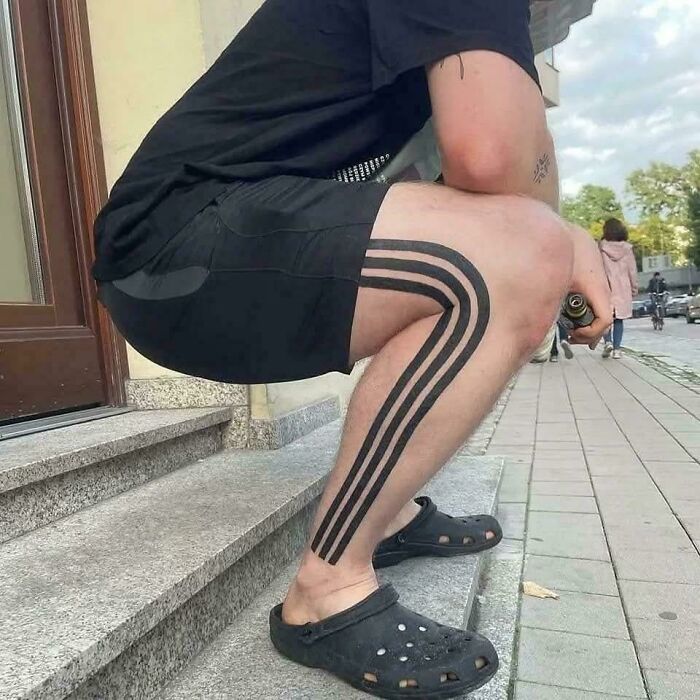 A man with a tattoo of three black stripes on his leg, resembling Adidas, one of many pics people cannot explain.