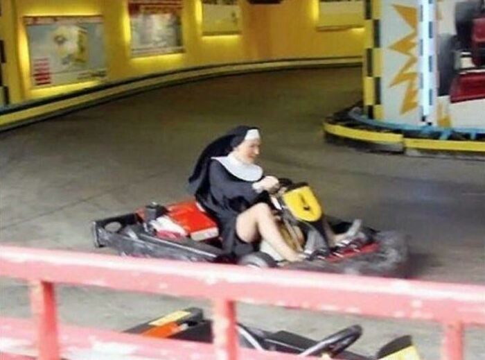 A nun playfully driving a go-kart on a track, a funny pic that people cannot forget.