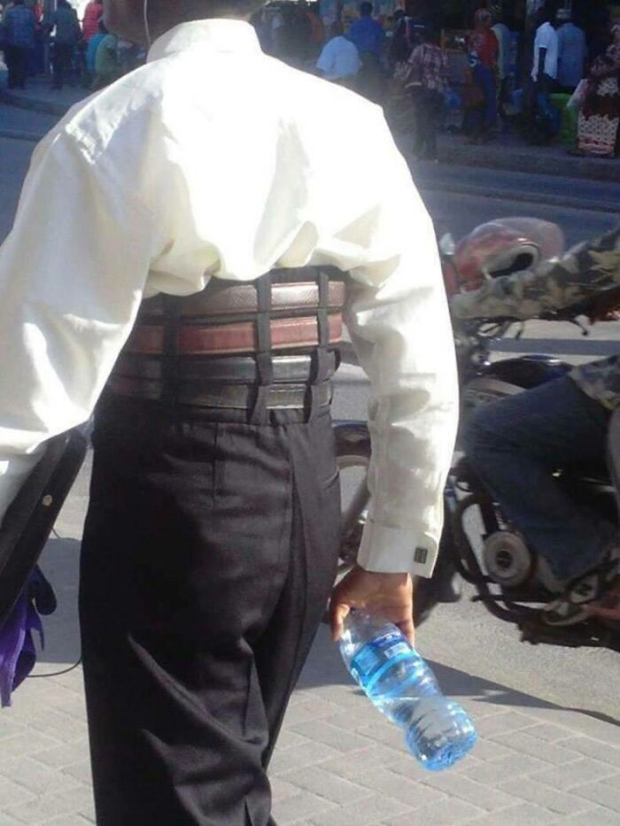 A man wearing many belts at once around his waist, an image that people cannot explain or forget.
