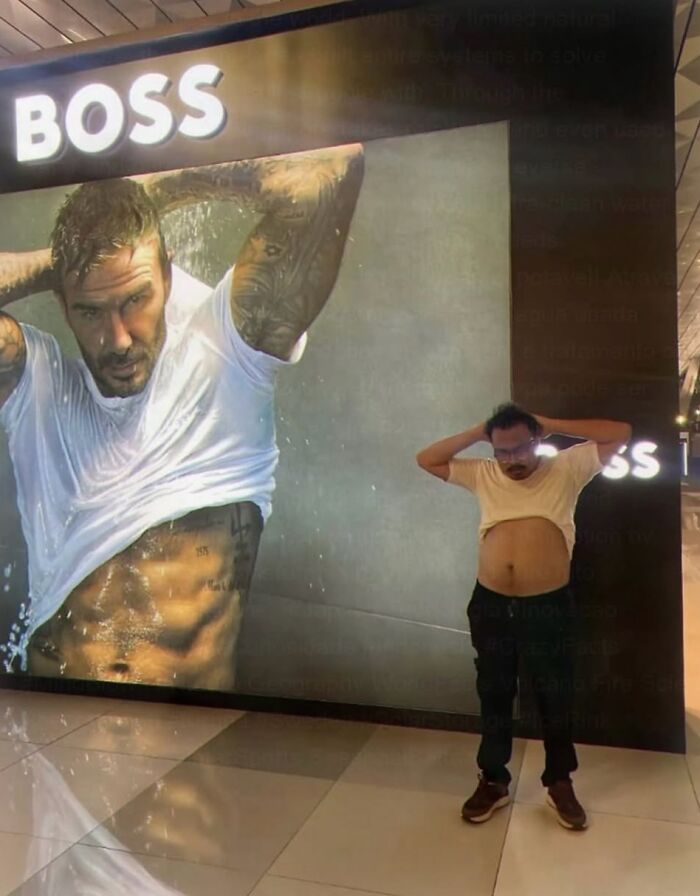 A confusing pic of a man posing like a David Beckham ad, with his belly out.