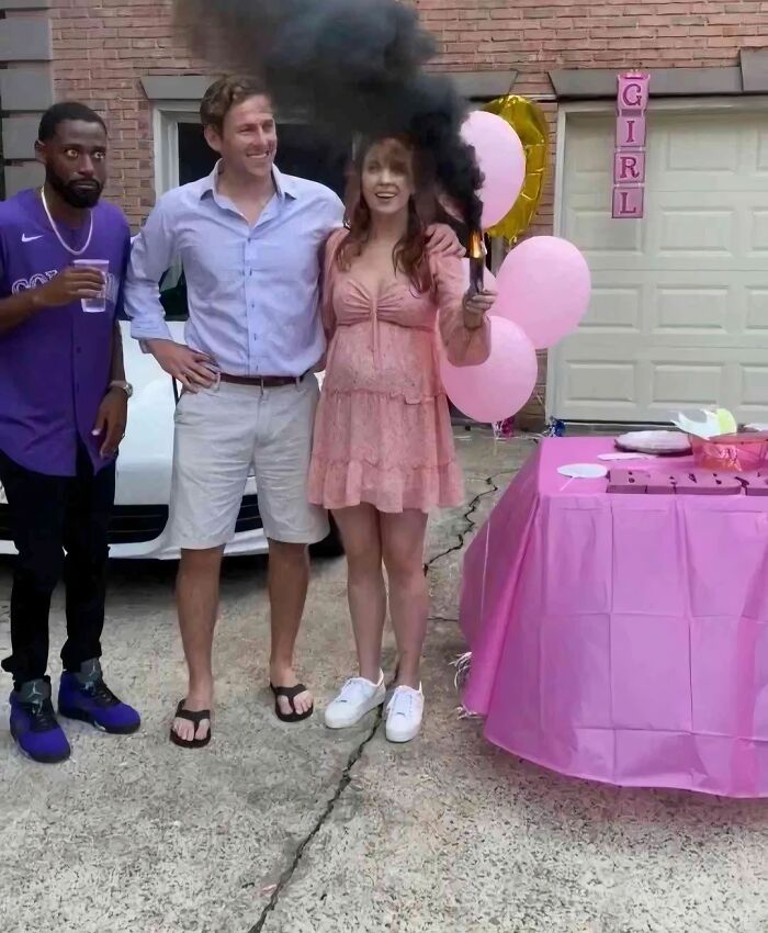 A couple and a man looking surprised at a black smoke cloud from a gender reveal, one of many pics people cannot explain or forget.