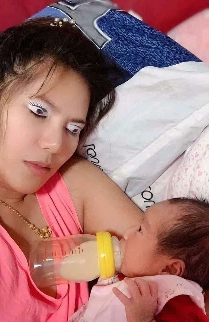 A mother with unusual eye makeup feeding a baby, a bizarre image among many pics people cannot explain.