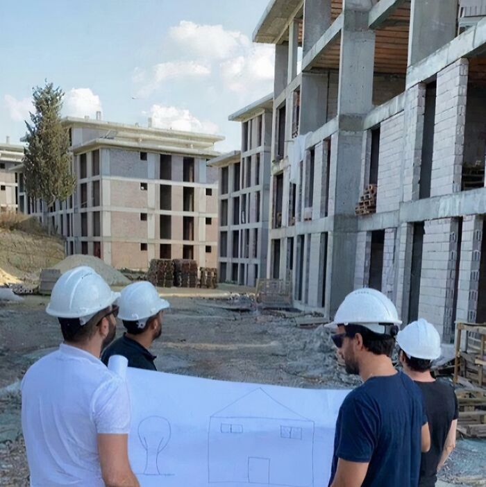 Four men in hard hats look at house plans at a construction site, one of many pics people cannot explain.