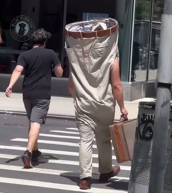 A person dressed in oversized pants as a full-body costume, walking on a city street, one of many pics people cannot explain.