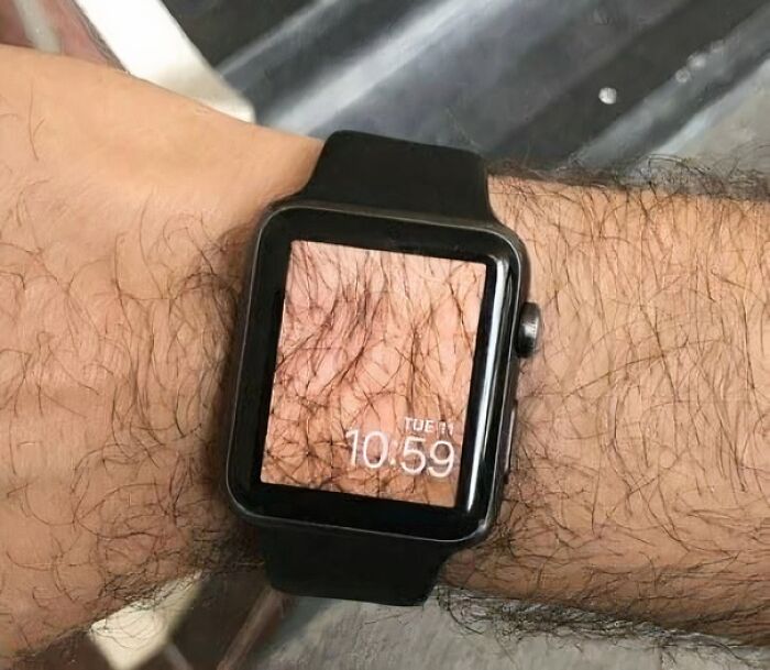 A person's wrist with a smartwatch displaying a hairy arm, an image that people cannot explain or forget.
