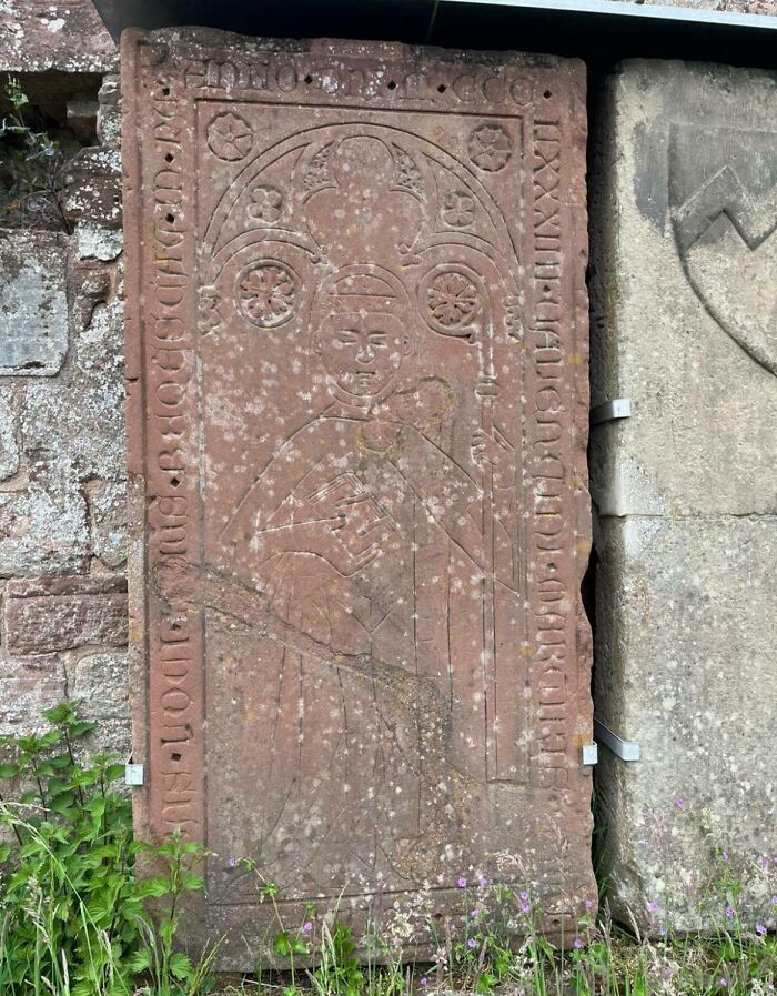 An ancient carved stone slab depicting a figure, offering a glimpse into the Middle Ages' human history.