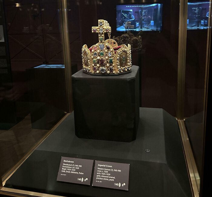 The Imperial Crown, adorned with gems, a splendid example of royalty from the Middle Ages.