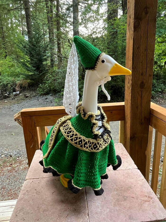 Crochet goose costume with green dress and hat on porch