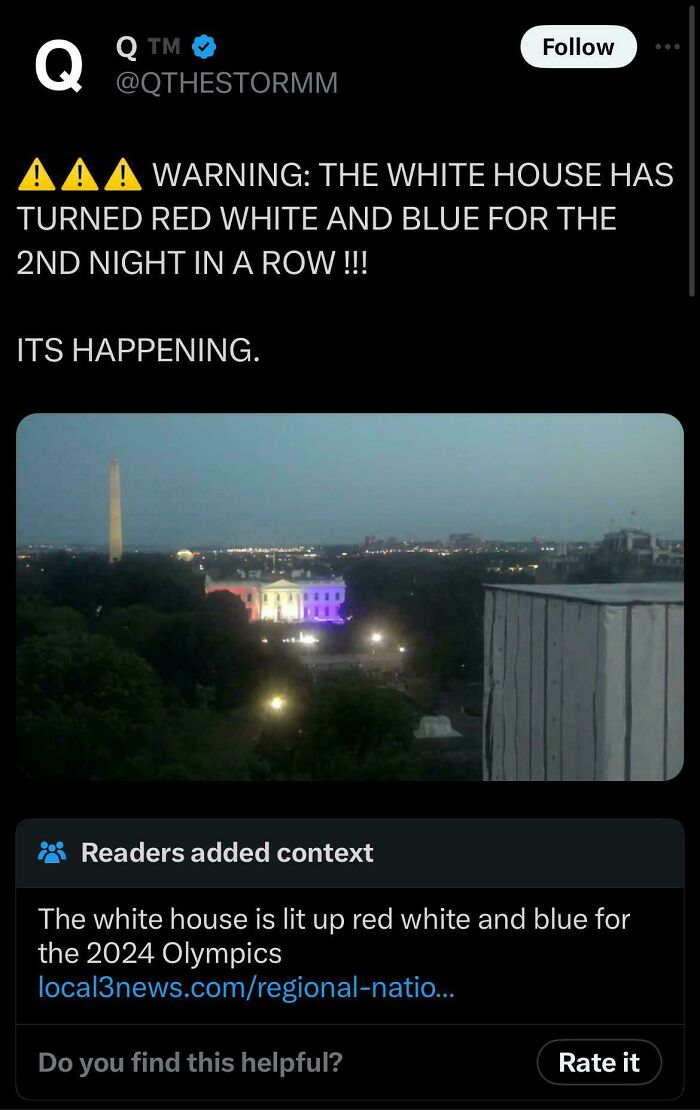 The White House lit up red, white, and blue at night, with a fact-checked note explaining it is for the 2024 Olympics.