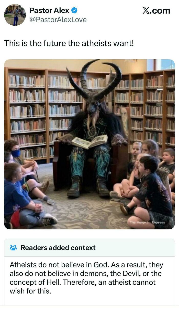 A horned figure in a library reading to children, with a fact-checked note clarifying atheists do not believe in demons.