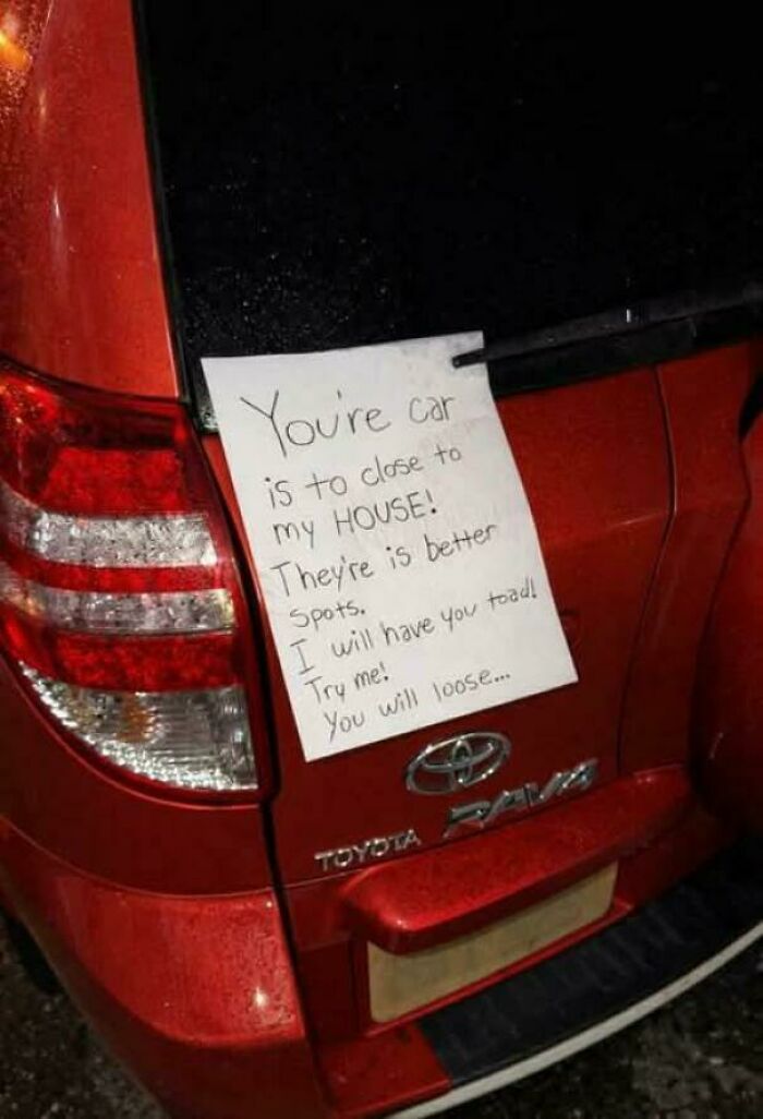 A note on a car's rear window, a lesson in parking from jerk neighbors.