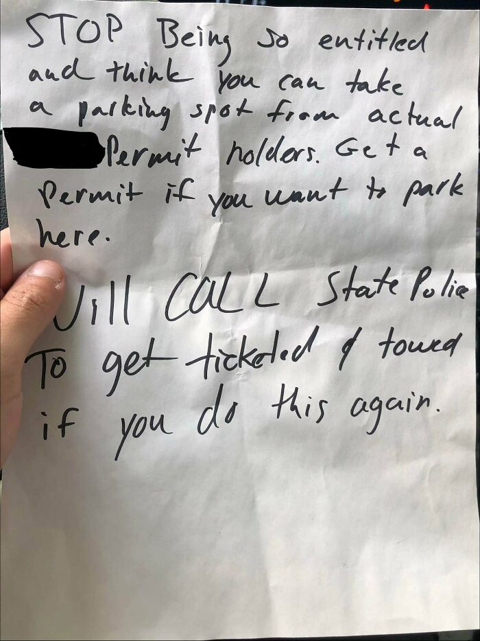A handwritten note threatening police action for poor parking, a clear sign of jerk neighbors.
