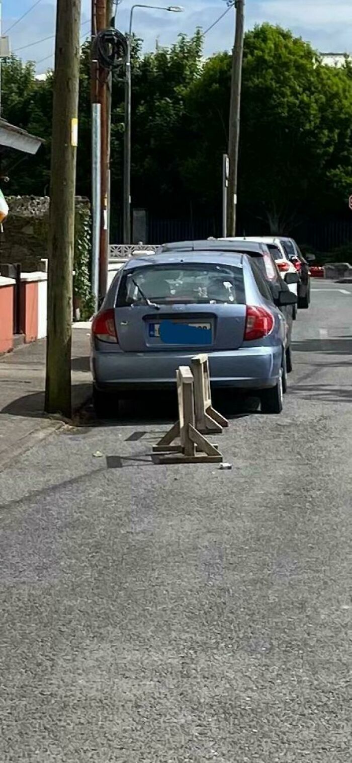 A poorly parked car blocking the pavement, illustrating a common problem with parking and neighbors.