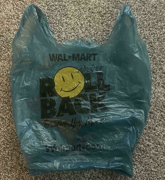 Blue Walmart plastic bag with the yellow smiley face and Roll Back logo, showing how much the past has changed.