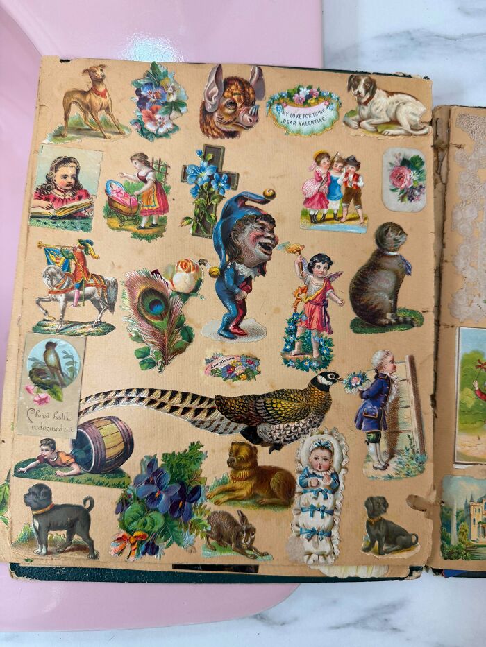 Vintage scrapbook filled with various ephemera, including cut-out images of animals, children, and decorative elements.