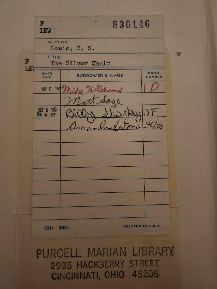 A vintage library card with handwritten names and dates, showcasing fascinating pieces of ephemera from the past.