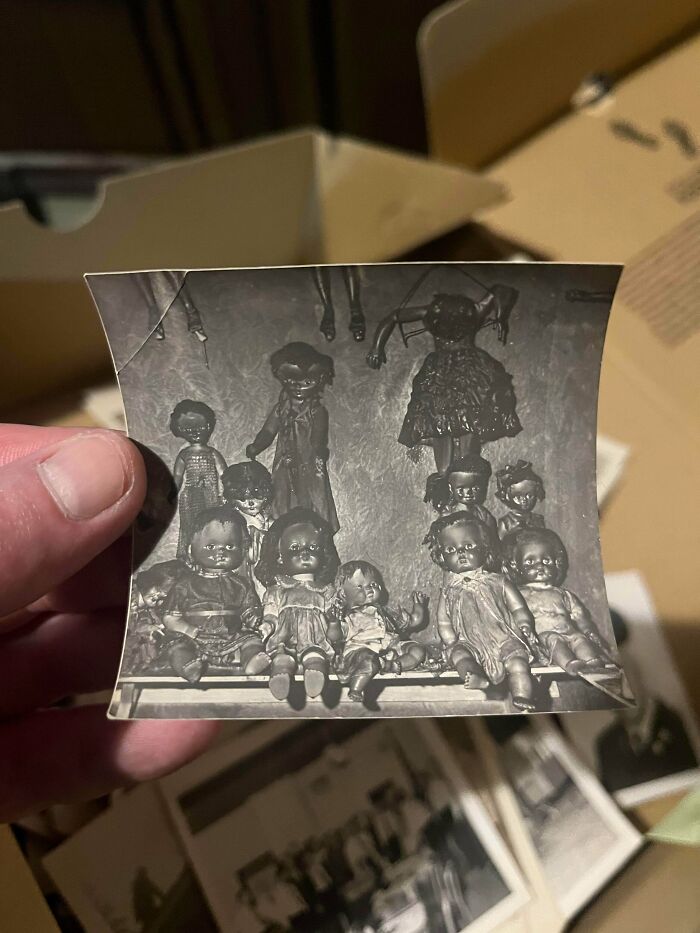 A black and white photo of antique dolls, a fascinating piece of ephemera from the past.