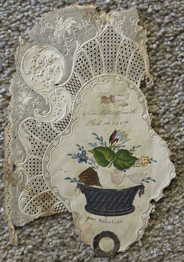 Intricate lace valentine from 1854 with a hand-painted floral design, a beautiful piece of ephemera from the past.