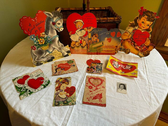 Collection of vintage Valentine's Day cards and a small photo, examples of ephemera from the past.