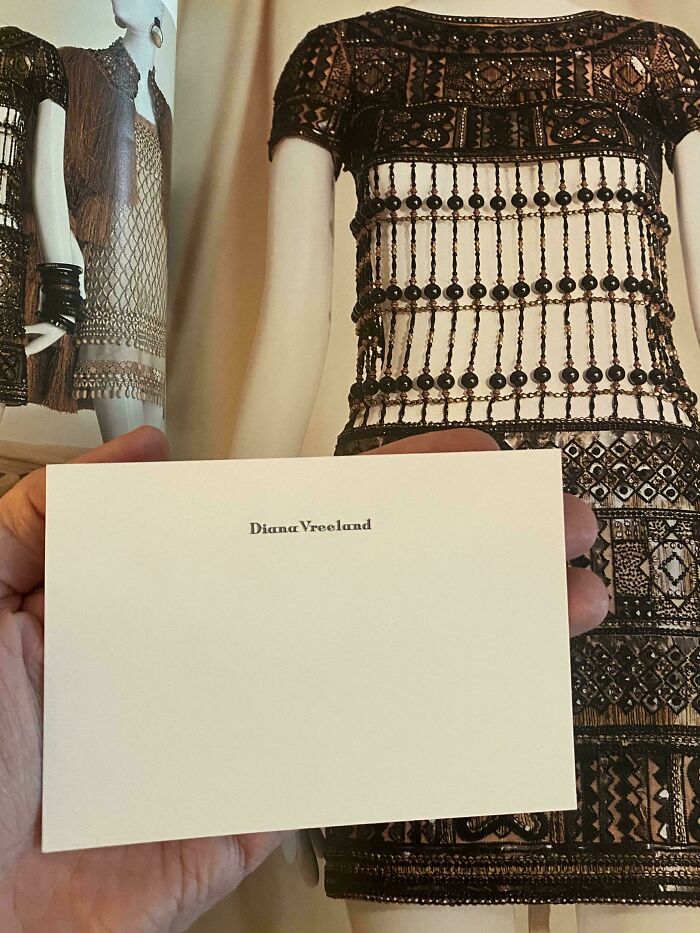Close-up of a vintage beaded dress on a mannequin with a Diana Vreeland card, showing fashion ephemera from the past.