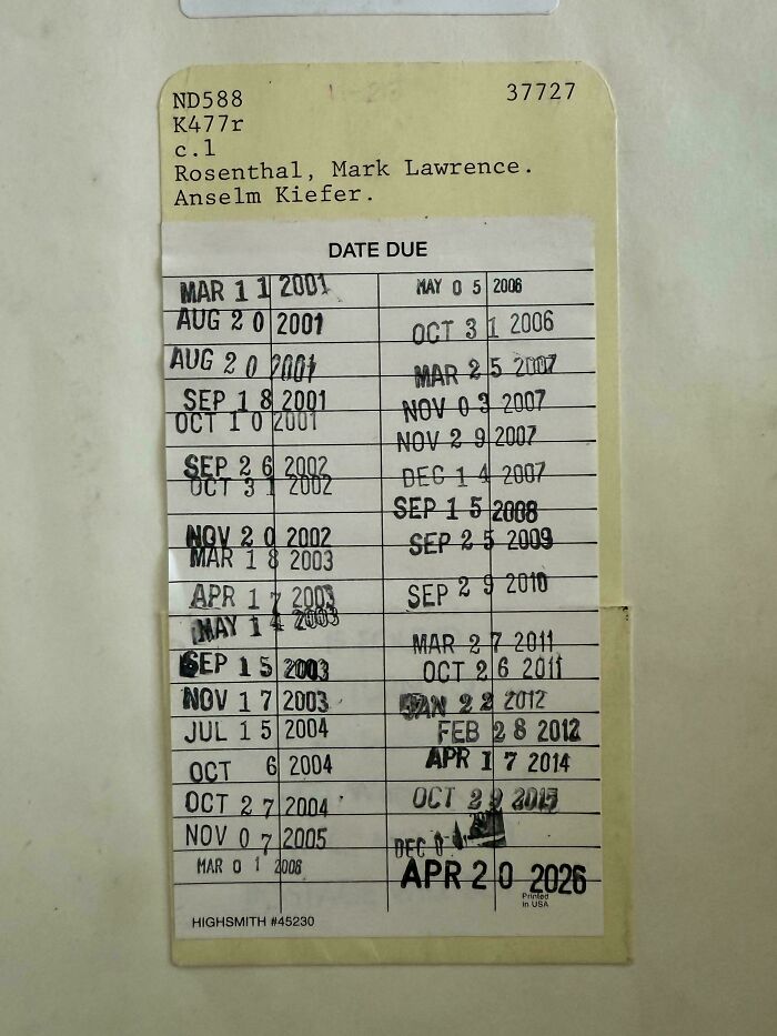 A library card with stamped due dates, highlighting how much the past has changed in terms of borrowing books, a piece of ephemera.